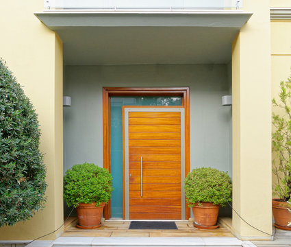 contemporary house cozy entrance wooden door and flower pots