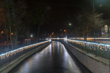 Radunia canal with Christmas decorations at night.