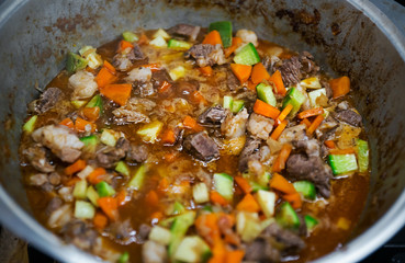 Meat stew with vegetables in a metal dishes. View from above