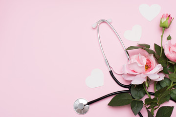 Stethoscope, rose and white hearts on pink background, copy space. valentine's day greeting card