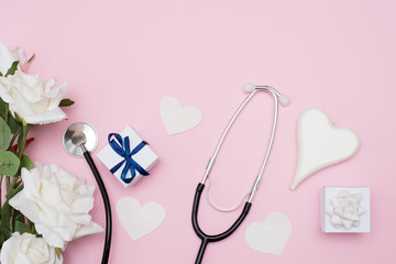 stethoscope with hearts, flowers and white gift box. copy space. valentine's day greeting card