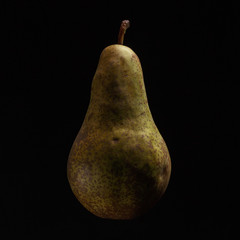 Juicy ripe pear on a black background