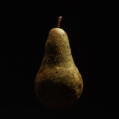Juicy ripe pear on a black background