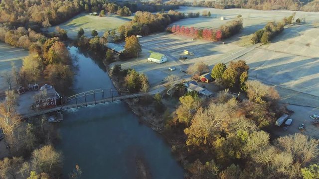 Early morning aerial view of grist mill by the river
