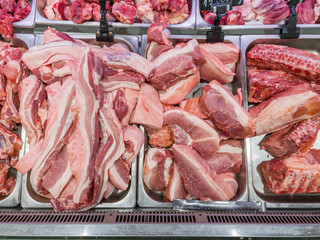 Pile of raw pork chop meat in the supermarket