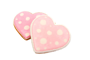 Background from pink cookies heart shaped with different patterns, isolated