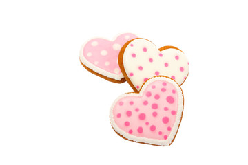 Background from pink cookies heart shaped with different patterns, isolated