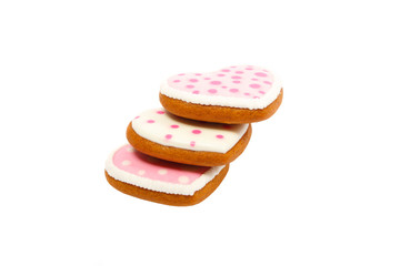Background from pink cookies heart shaped with different patterns, isolated