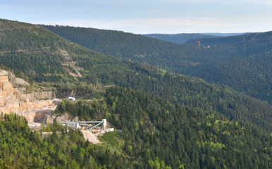 View of a quarry for stone mining in the European mountains. Industrial landscape mining