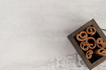 Natural Cinnamon stick in wood box on white  background with copy space.