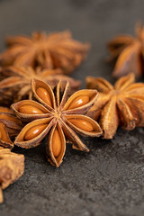 Natural anise star spice on dark concrete background.Close up