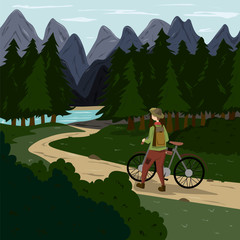 A man with a bicycle goes along a path in the forest with a mountain landscape on the horizon.
