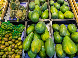 Fresh papaya and pineapple for sale at the fruit store