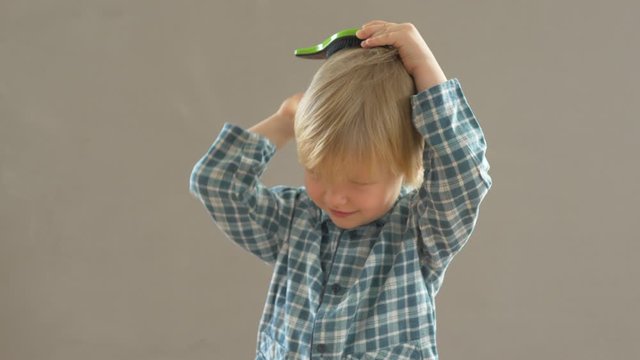 Portrait of funny child in new glasses with green spot to correct strabismus Orthopedic Boys Eye Patches nozzle for glasses for treatment of strabismus (lazy eye). Boy puts on and corrects glasses