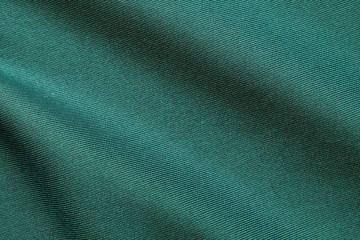 Top view of Beautiful cloth fabric texture background of green dress. Soft surface detail with wave and motion. Decorative, fashion concept with copy space for text.