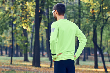 Man preparing for jogging / exercising in the park.