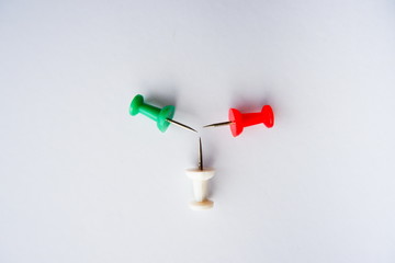 Top view of push pins on white paper background