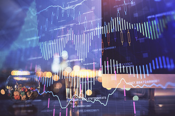 Financial graph colorful drawing and table with computer on background. Multi exposure. Concept of international markets.