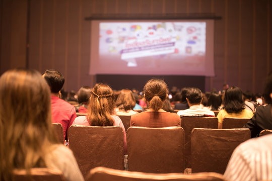 Speakers on the stage with Rear view of Audience in the conference hall or seminar traning