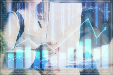 Double exposure of hands making notes with forex chart huds. Stock market concept.