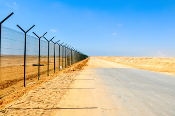 Security fence wall of the airport in the desert 