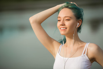 beautiful young woman in sportswear near a lake in summer