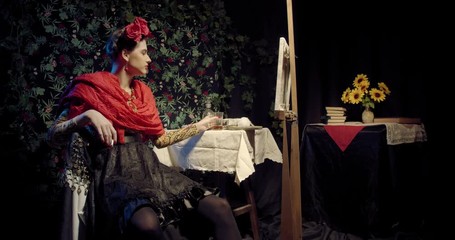 Young Frida Kahlo with a cigarette in her hand is drinking booze in her room, 4k