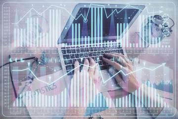 Multi exposure of forex graph with man working on computer on background. Concept of market analysis.