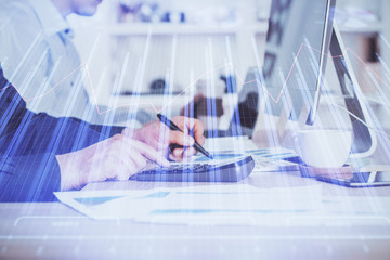 Forex graph with businessman working on computer in office on background. Concept of hardworking. Closeup. Multi exposure.