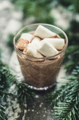 Glass of hot chocolate with christmas decorations on the rustic background. Selective focus. Shallow depth of field.