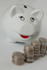 Piggy bank with coins on a white background. Saving money concept.