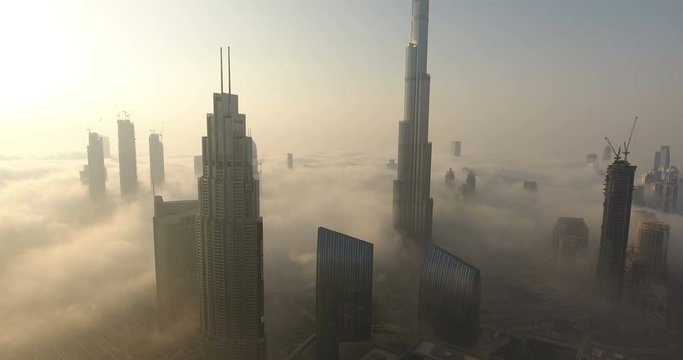 DUBAI, UAE - JANUARY 2, 2017: Aerial view of Burj Khalifa downtown Dubai at sunrise. The Burj al Khalifa is the tallest structure in the world, standing at 829.8 m (2,722 ft). Scenic foggy weather.
