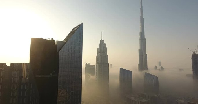 DUBAI, UAE - JANUARY 2, 2017: Aerial view of Burj Khalifa downtown Dubai at sunrise. The Burj al Khalifa is the tallest structure in the world, standing at 829.8 m (2,722 ft). Scenic foggy weather.
