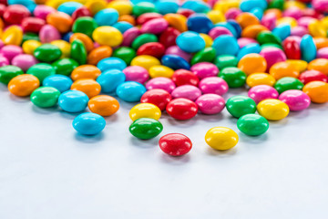 Colorful candy sweets on white background - closeup with selective focus.