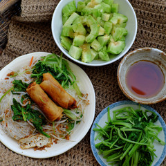 vietnamese vegetarian food for breakfast, rice noodle with fried spring roll, vegetables for vegan meal