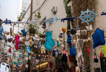 Naklejka premium Store display with handmade souvenirs in Polignano a Mare. Apulia, Bari province, Italy,