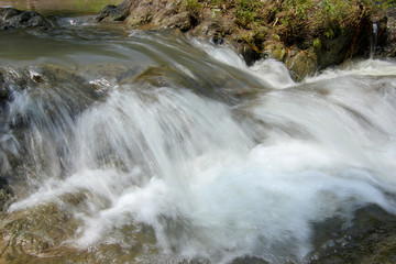 Slow motion waterfalls running at a stream