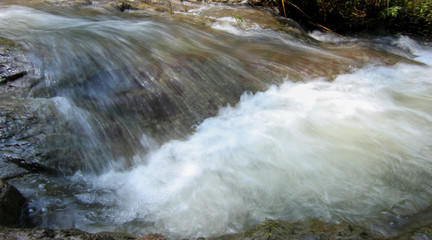 Slow motion waterfalls running at a stream
