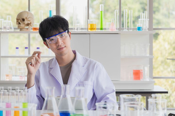 Fototapeta premium Asian male scientist stand and smile in lab room..