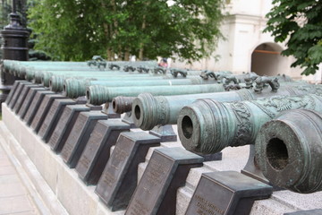 Historic cannon and balls in front of a church at the Kremlin. War and Peace united at the Kremlin.