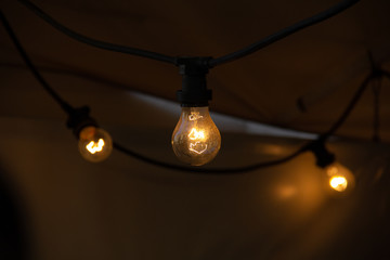 Light bulbs in the ceiling of a tent