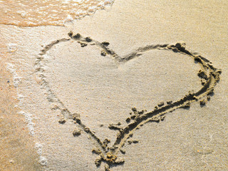 Heart drawn on the beach sand