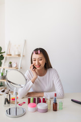 young beautiful woman applying her make-up