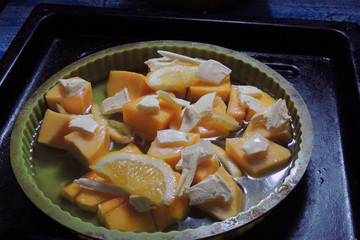 pumpkin with butter and orange in the oven