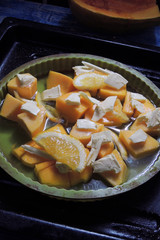 pumpkin with butter and orange in the oven