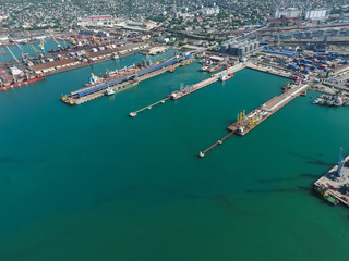Industrial seaport, top view. Port cranes and cargo ships and ba