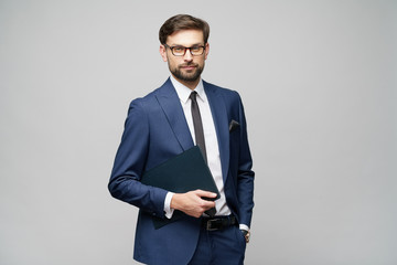 Portrait of a handsome young business man holding document folder