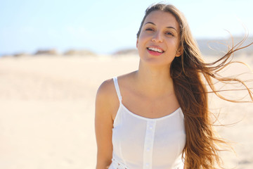 Close up of smiling brazilian girl on the beach in summer holidays looking at camera