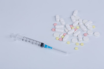 White pill, syringe and heroin on spoon. Drug addiction.