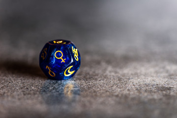 Blue Astrology Dice with symbol of the planet Venus on grey background